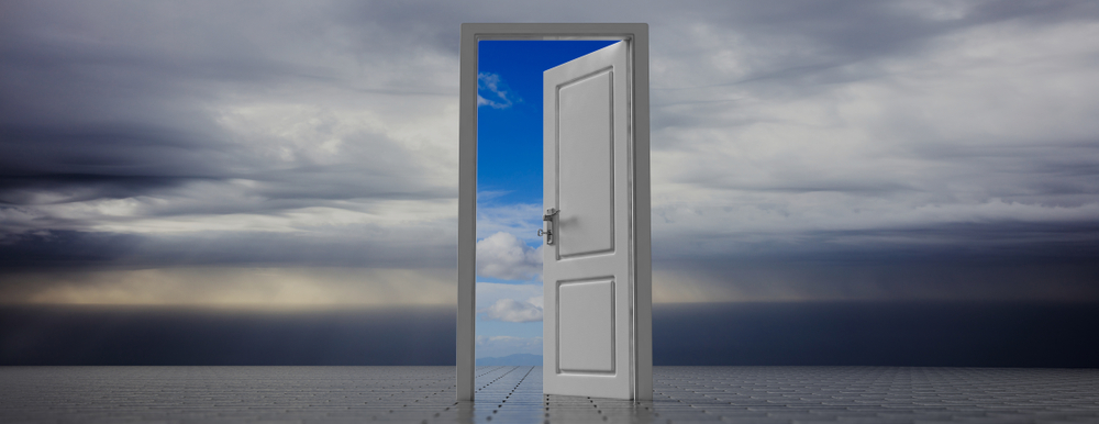 Image of a door opening to blue sky